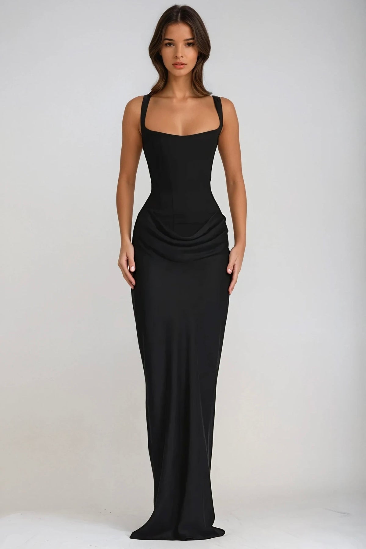 Model standing facing forward in the black maxi dress, full length with arms by her sides 28