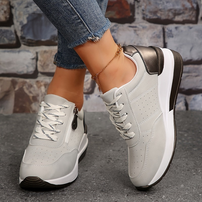 Light grey perforated trainers with white laces and zip, worn with cropped frayed jeans 5