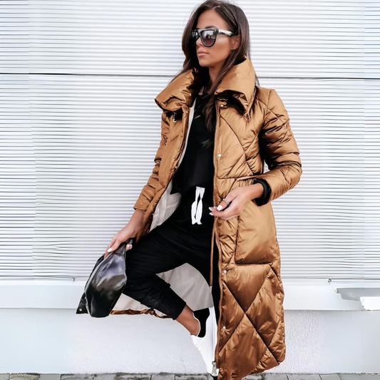 Same long quilted puffer coat in a glossy bronze-brown shade, worn open by a woman with sunglasses and a black bag. 2
