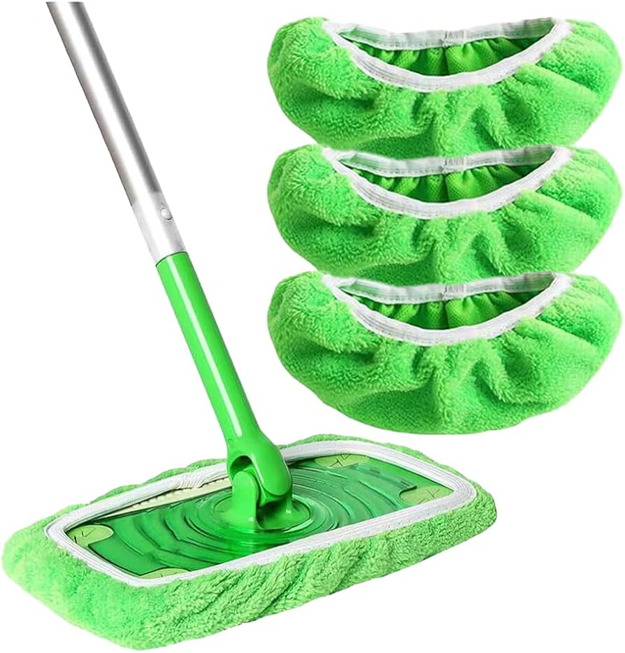 Green flat mop with a green microfibre pad fitted, next to three spare green pads stacked on the right. 6