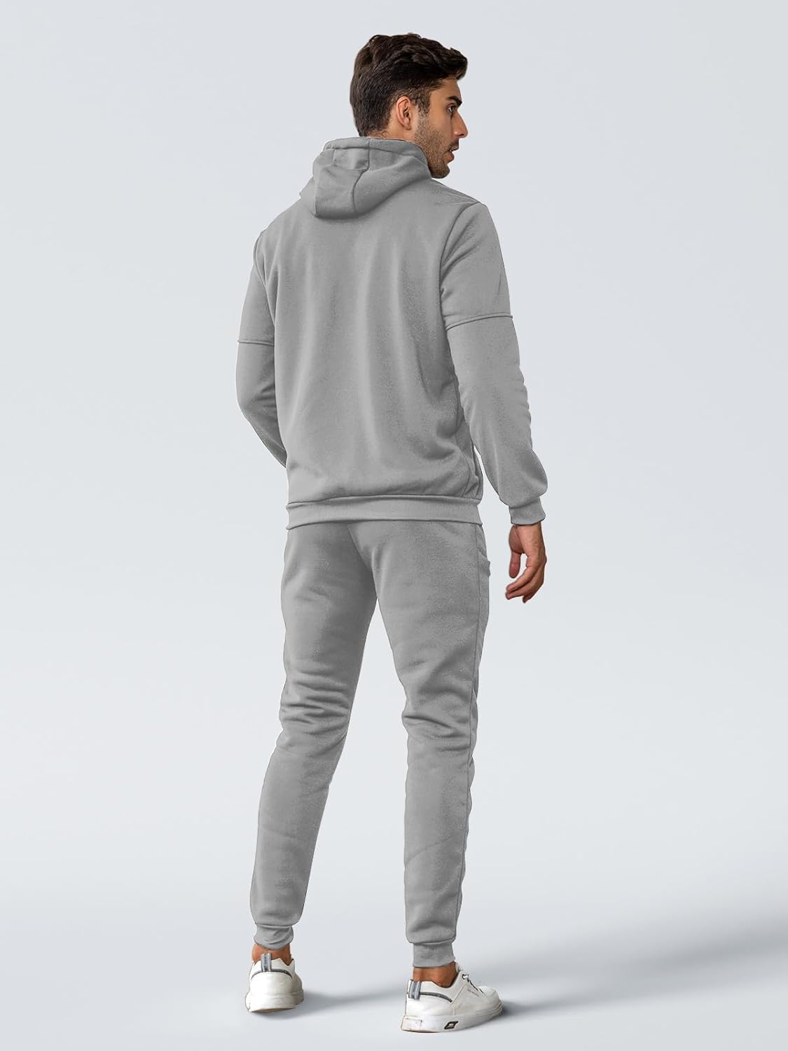 Back view of a man wearing the light grey hooded tracksuit with joggers 11