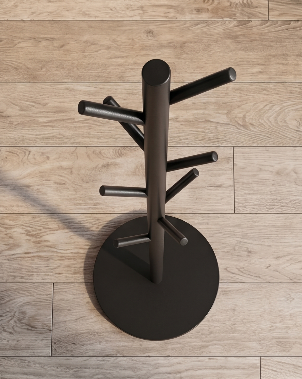 View from above of the black rack on a wooden floor, showing the round flat base and hooks radiating from the pole. 6