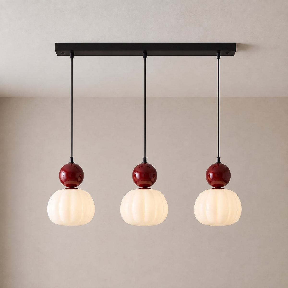 Three-head pendant with red caps and fluted shades hanging from a black rectangular canopy 11
