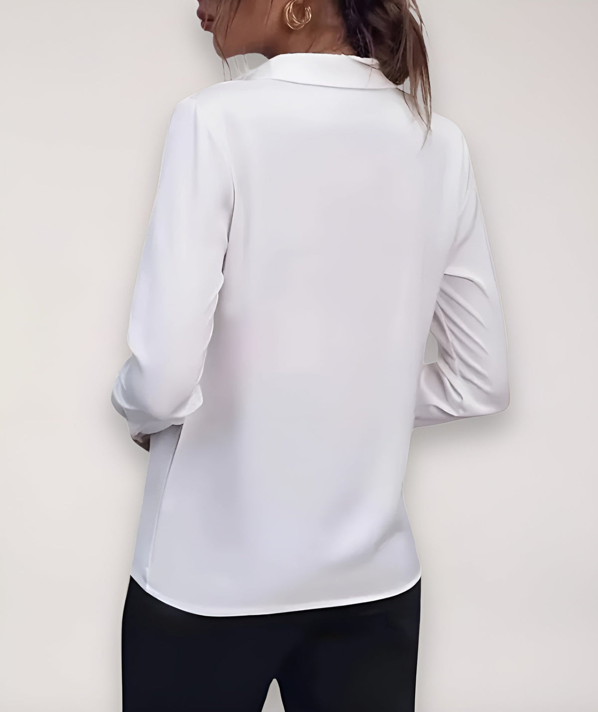Back view of the white blouse on a model, showing the collar and long sleeves 6