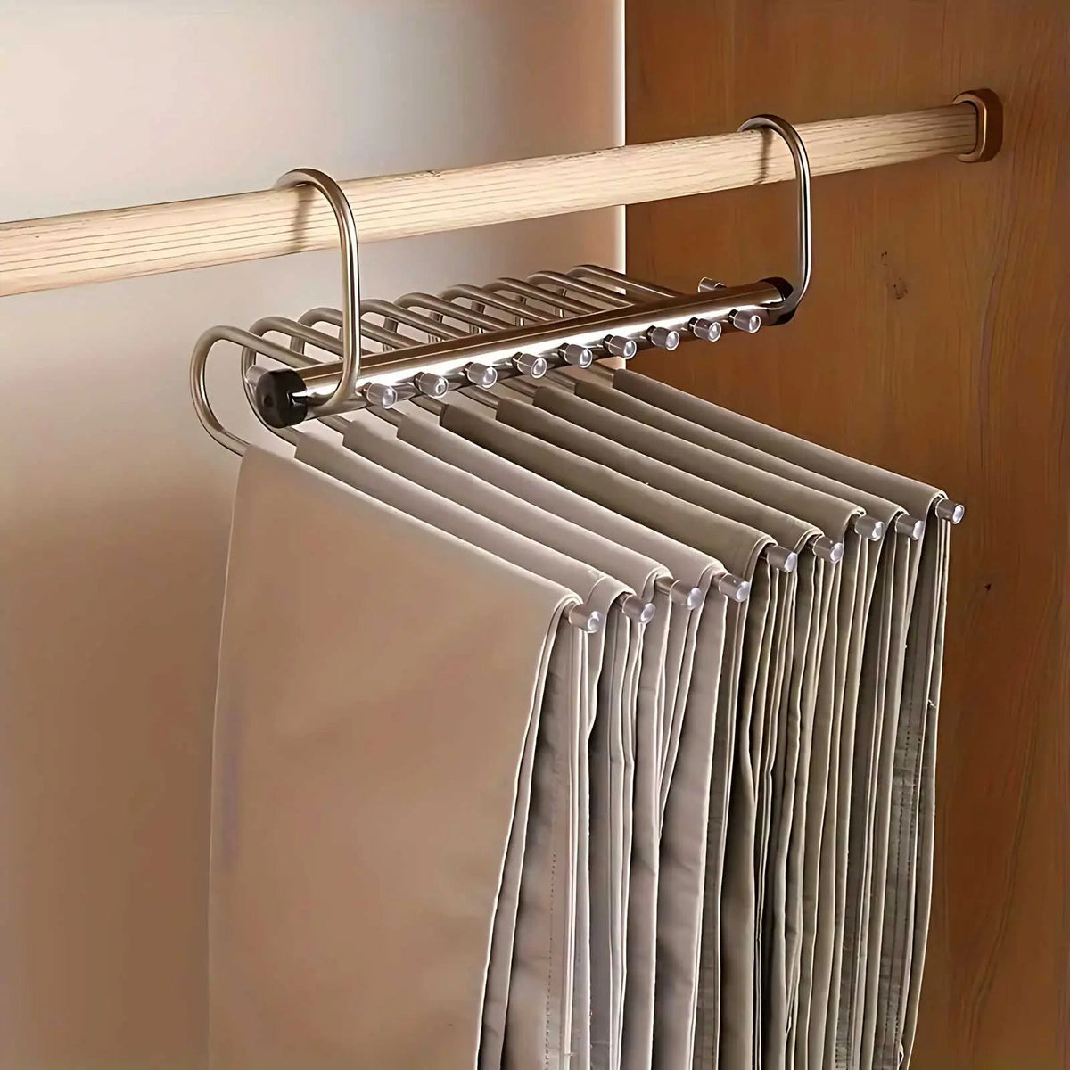 Silver multi-bar hanger opened out sideways along a wardrobe rail, with a row of trousers hanging from its bars. 5