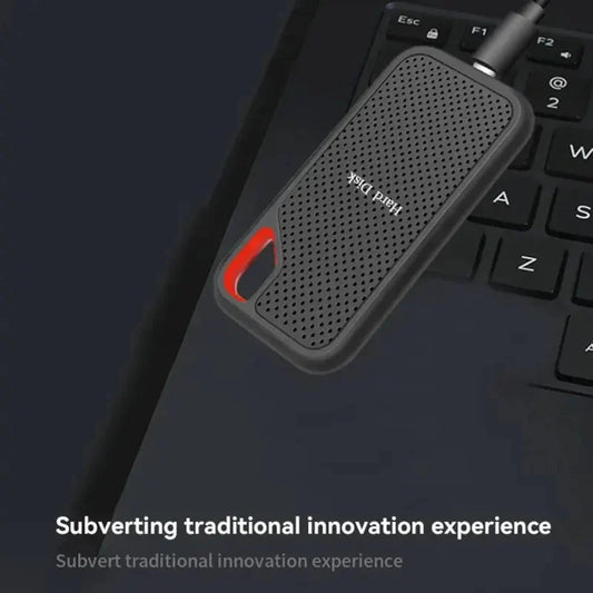 Portable SSD plugged into a laptop and resting on its keyboard, shown in use 2