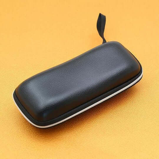 Closed black leather-look zipped glasses case with a wrist loop on an orange background 11