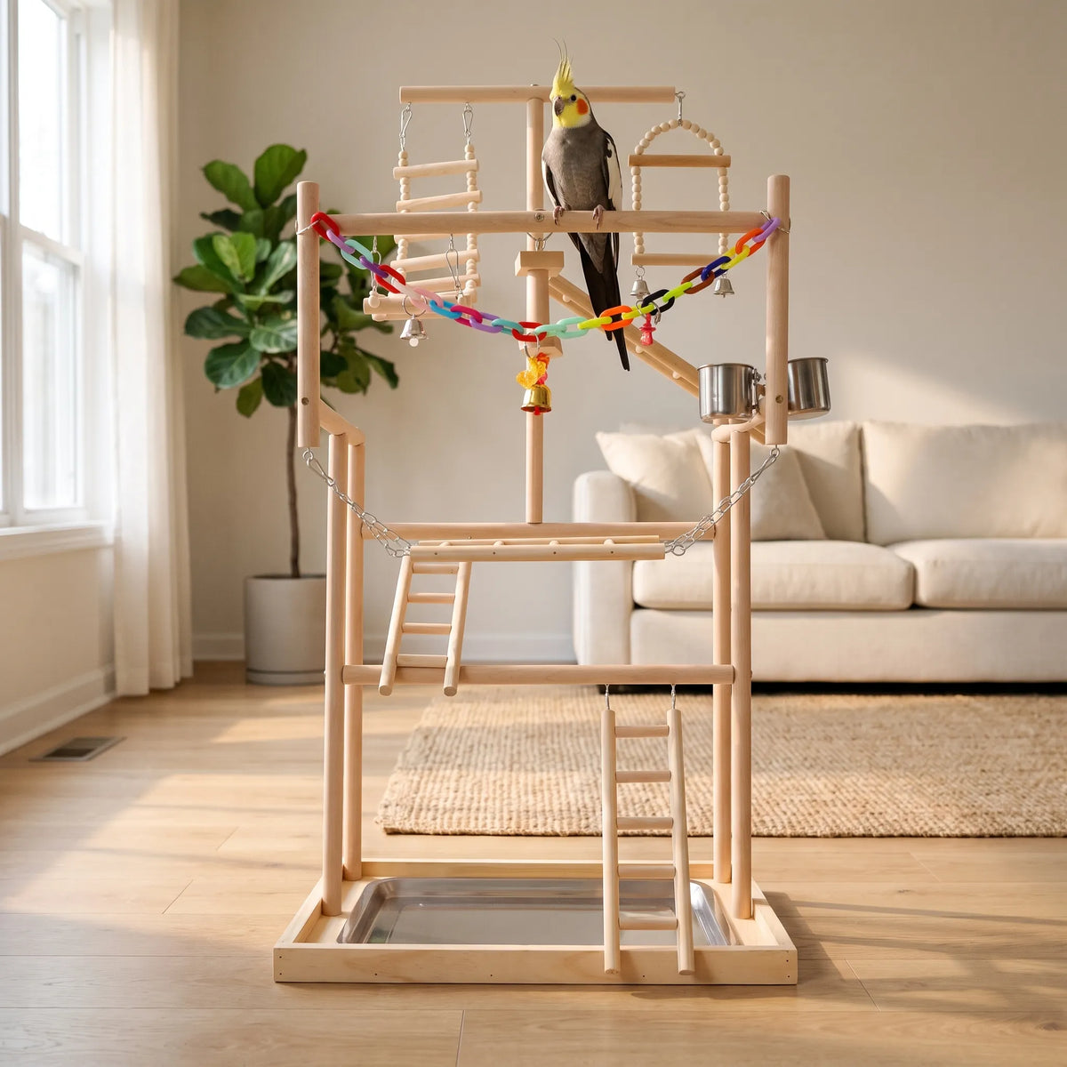 Wooden bird play stand in a cosy living room with a cockatiel on a crossbar, a plant and sofa behind. 3