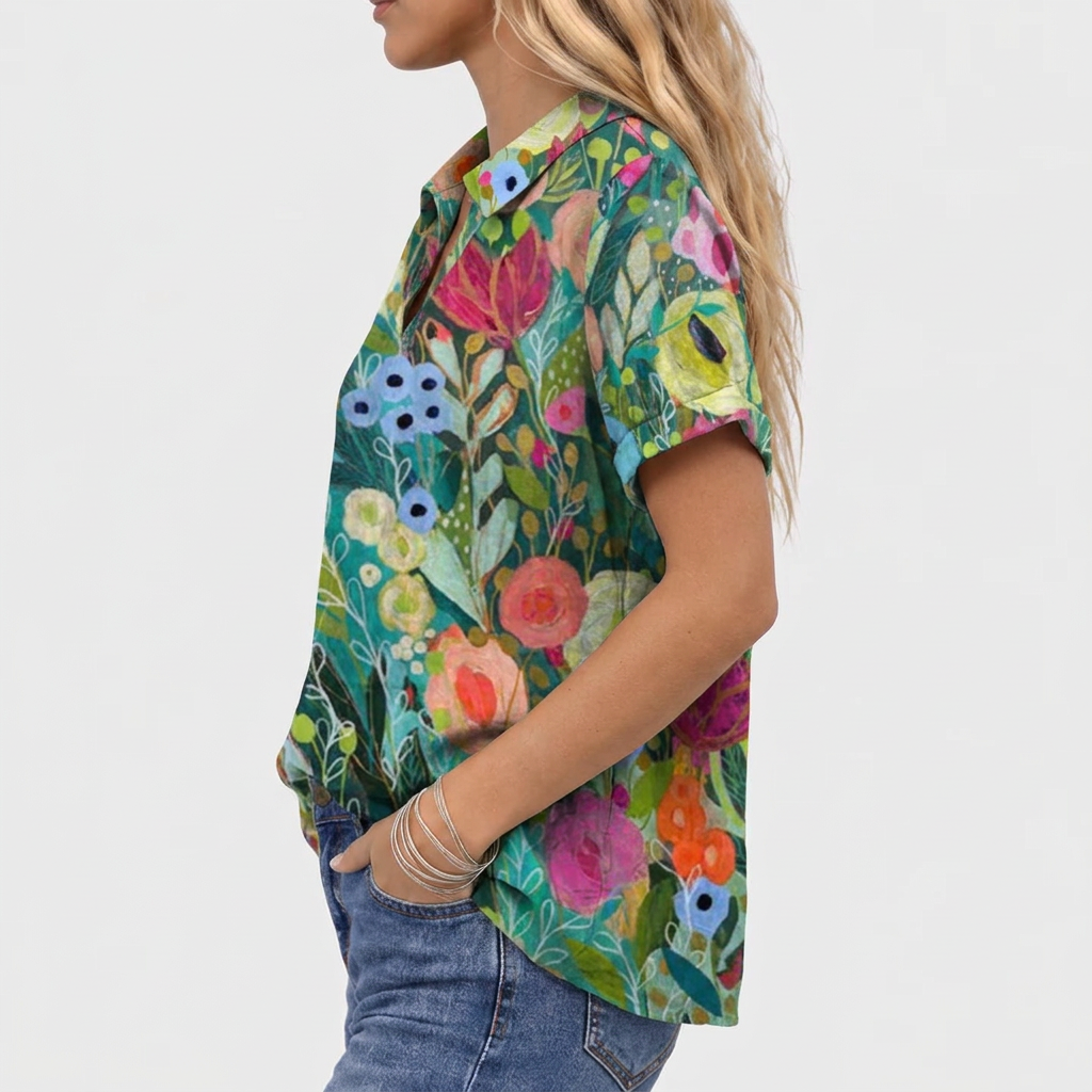 Side view of the floral top on a model, showing the collar and cuffed short sleeve 3
