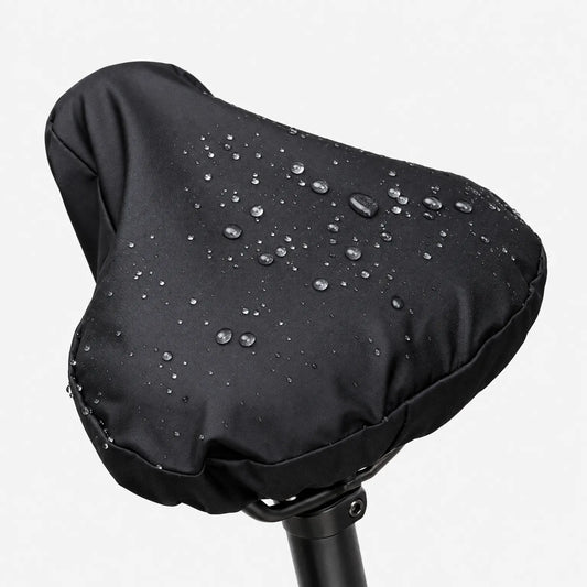 Close-up of the black side of the cover on a saddle, with raindrops sitting on the smooth fabric against a white background. 2
