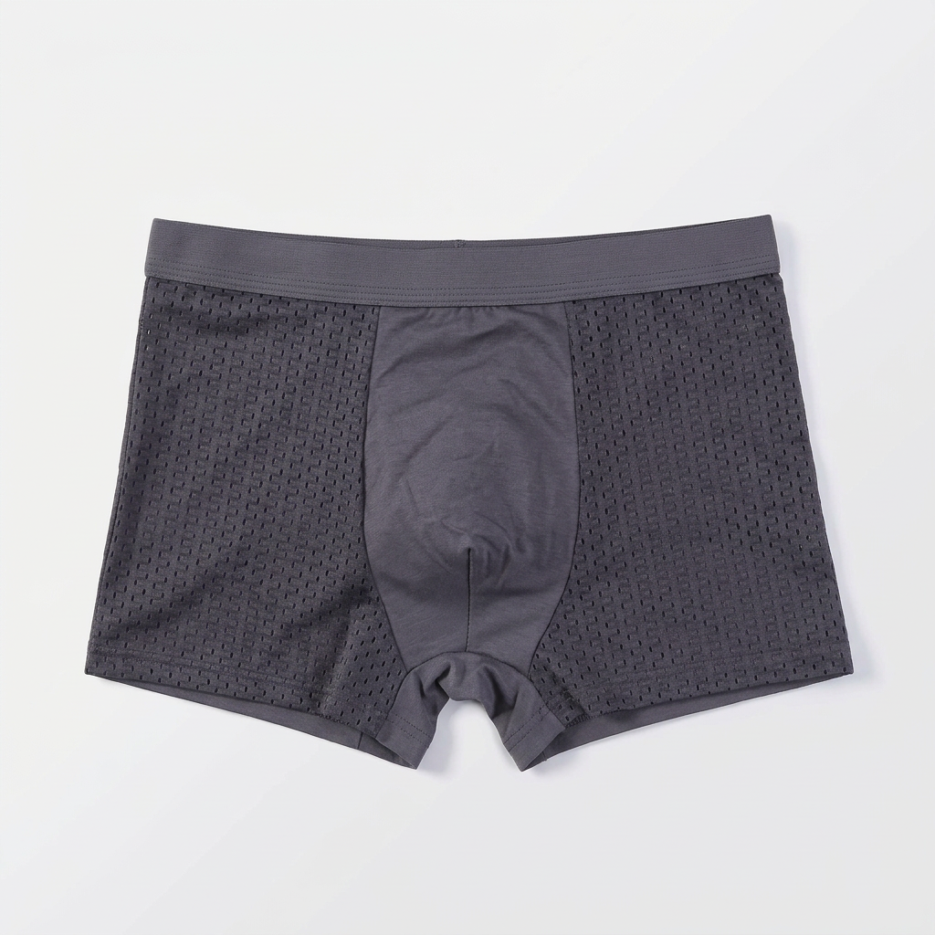 Single grey boxer short laid flat, showing the smooth centre panel and perforated mesh sides 4