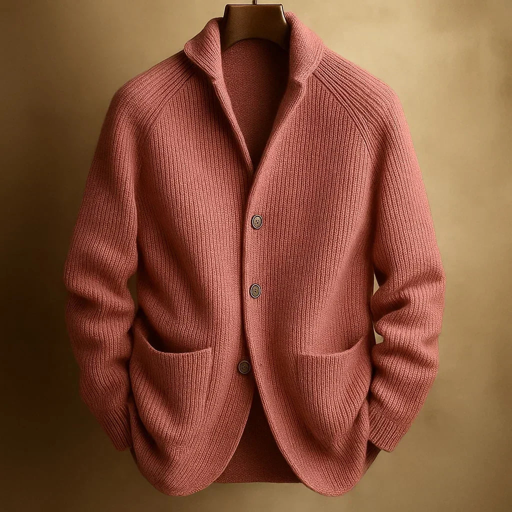 Terracotta pink ribbed knit cardigan with shawl collar and three buttons, hanging against a warm golden backdrop 6