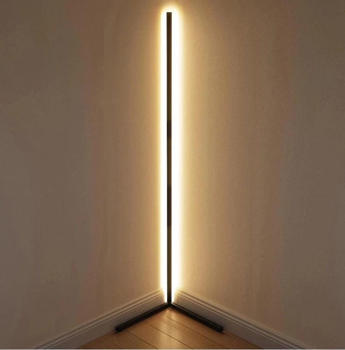 Close view of the lamp tucked into a room corner, glowing warm white along its full height 12