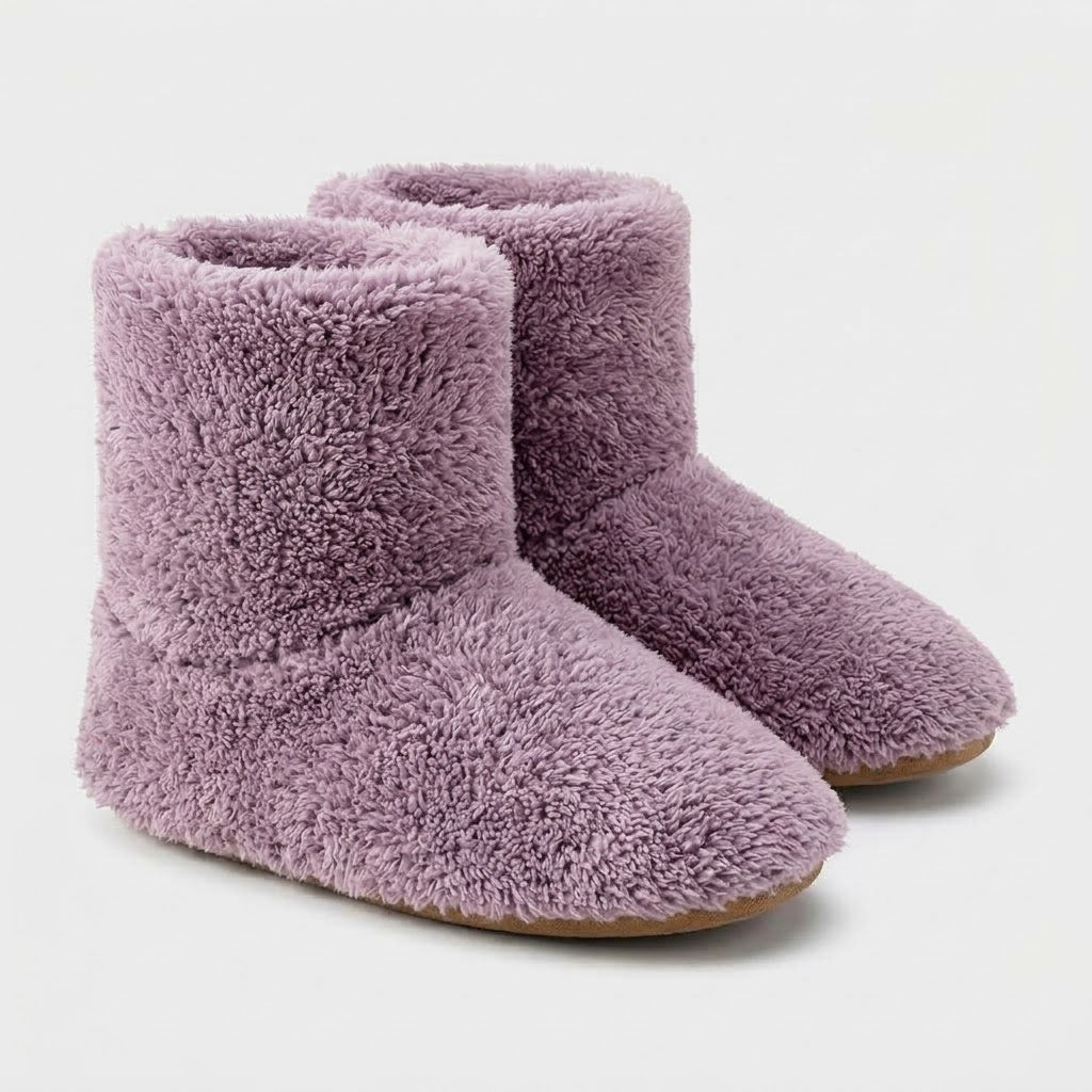 Pair of mauve plush ankle-high slippers on a plain pale background, shown from the front and side with tan soles. 7