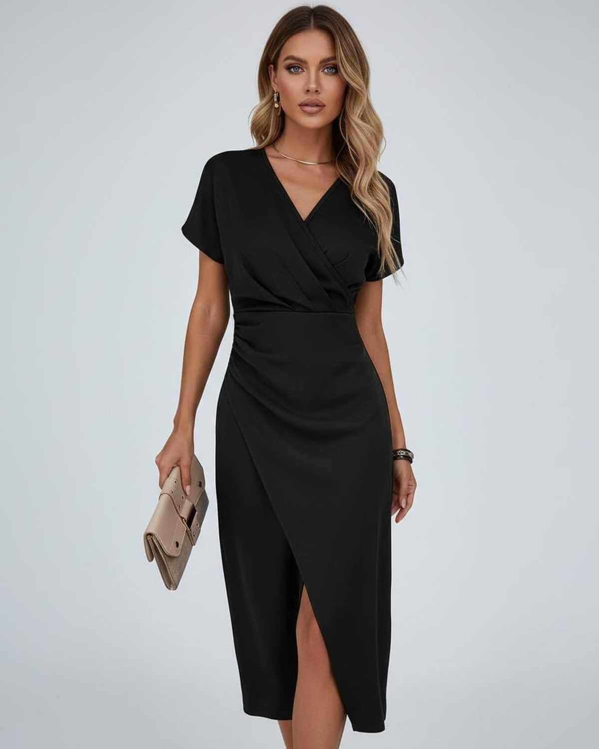 Model wearing the black version, holding a beige clutch bag, front view 5
