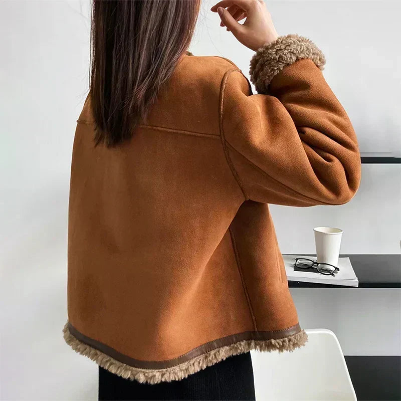 Back view of the jacket on a model, showing smooth suede panels and a fleece-trimmed hem 3