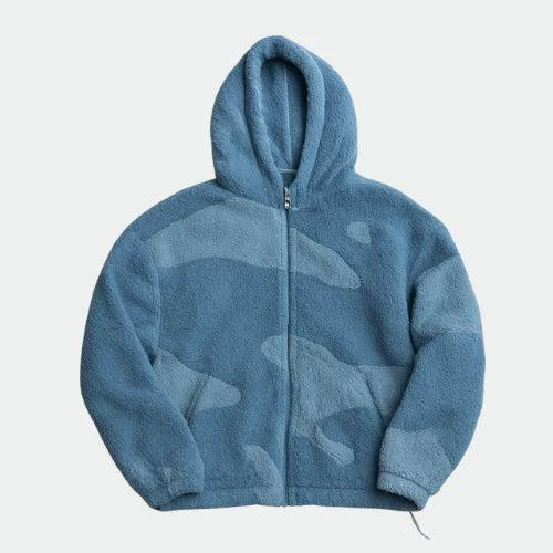 Front view of a zip-up hooded fleece jacket in two tones of blue with a soft camouflage-style panel pattern. 3