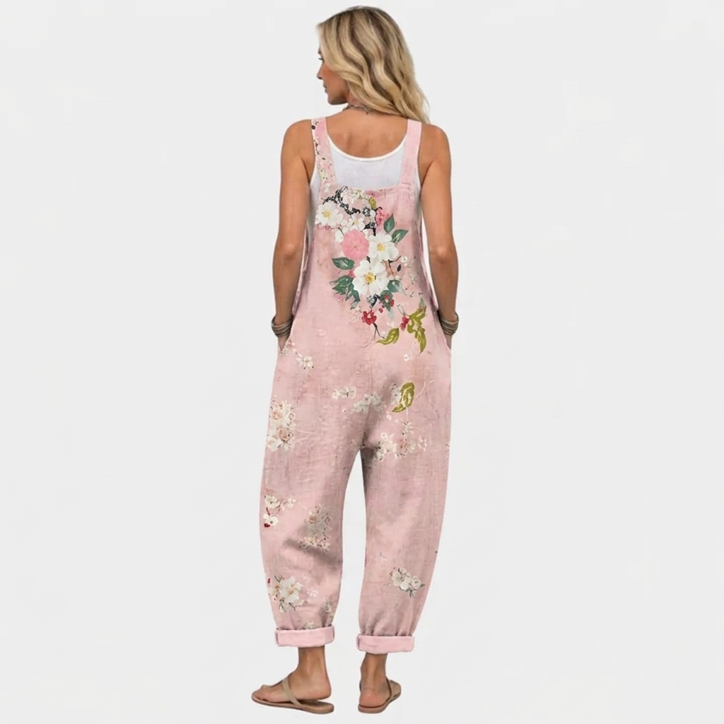 Back view of the overalls on a model, showing the same floral bouquet print across the back and straps. 4