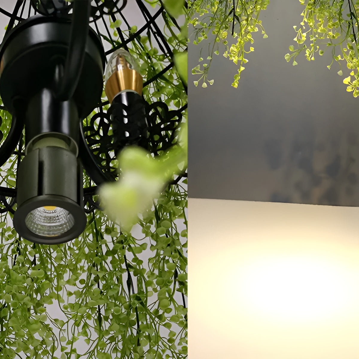 Close-up of the black metal light fittings and candle-style bulb inside the foliage, beside a glowing ceiling reflection 9