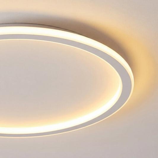 Close-up of the light's white ring edge and softly glowing inner band, showing the thin profile and warm glow on the ceiling. 2