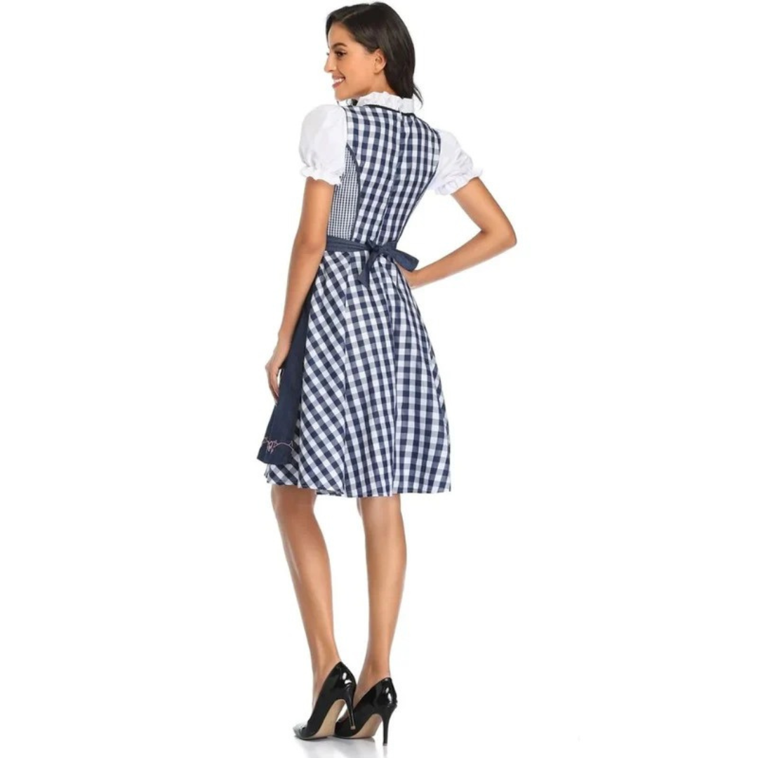 Back view of the navy and white gingham dirndl showing the checked bodice back and the navy apron tied in a bow. 11