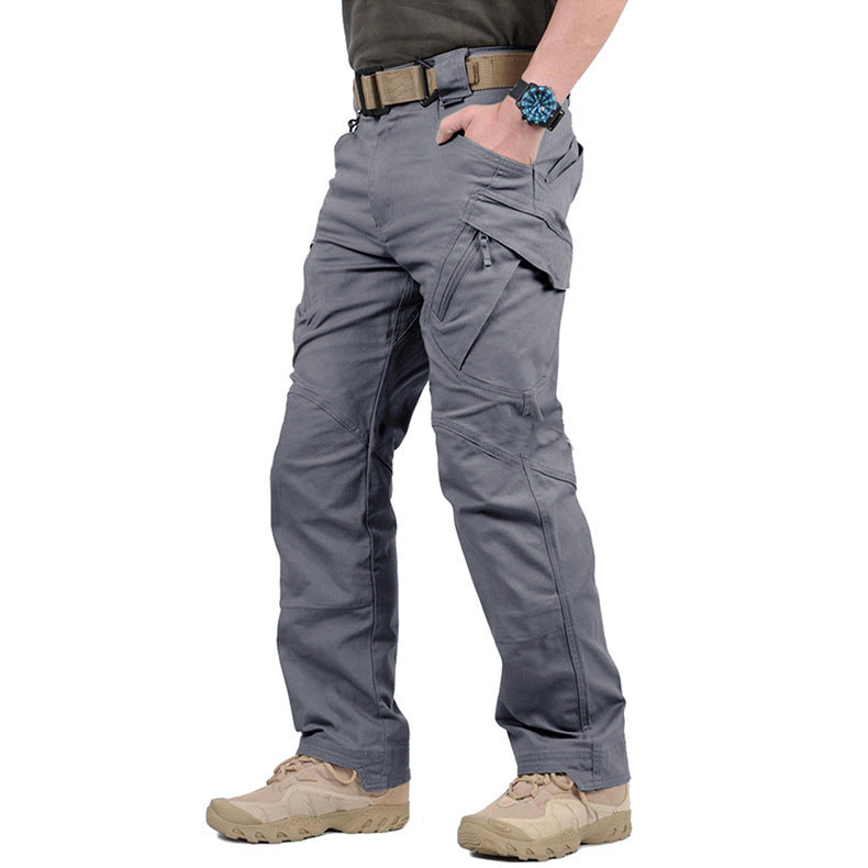 Side view of the trousers in grey, worn with a tan belt and desert boots 6