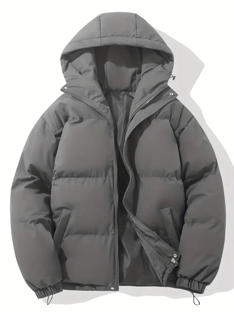 Charcoal grey hooded puffer jacket laid flat, zip partly open showing the dark lining 8
