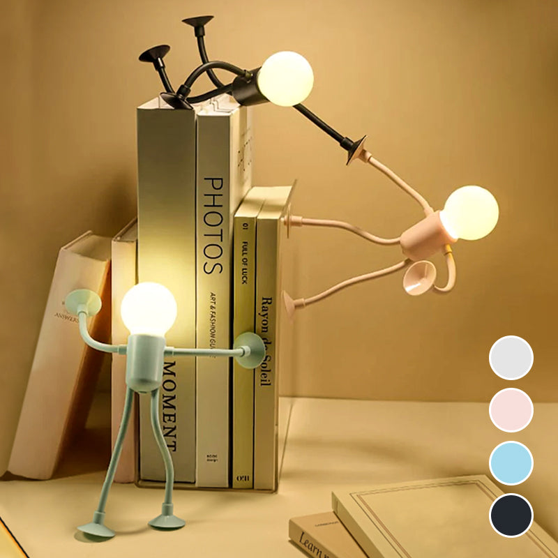 Glowing figure lamps in green, pink and black pose against a row of books, with four colour swatches at the corner. 5