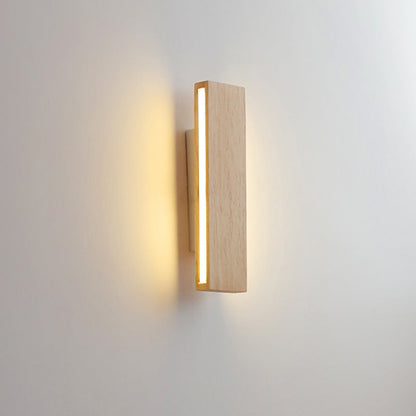 Side-on view of the vertical wooden bar with a glowing edge strip lighting the wall behind it. 10