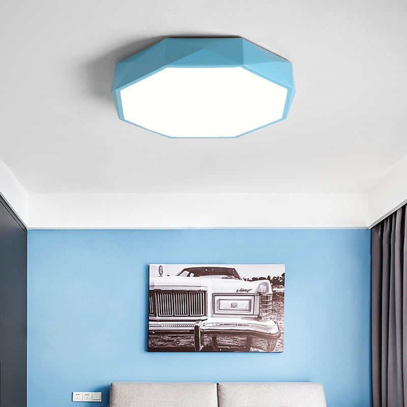 Blue faceted octagonal ceiling light above a blue wall with a black and white car print 3