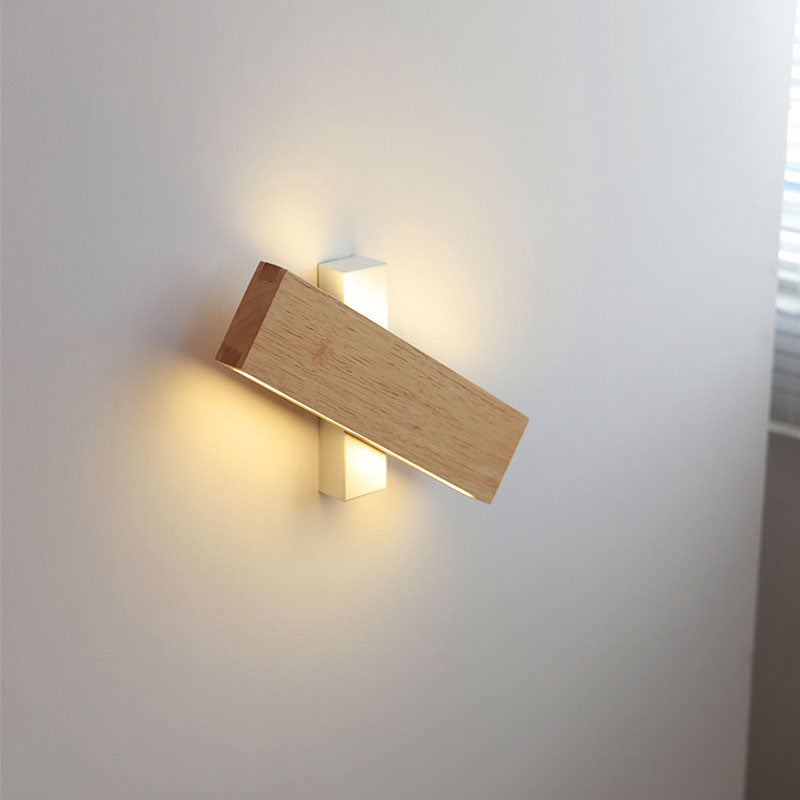 Wooden bar swivelled across its white wall bracket, with warm light glowing above and below. 9