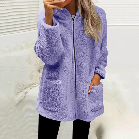 Model wearing the zipped fluffy fleece jacket in lilac purple with black leggings, hand in a pocket 4
