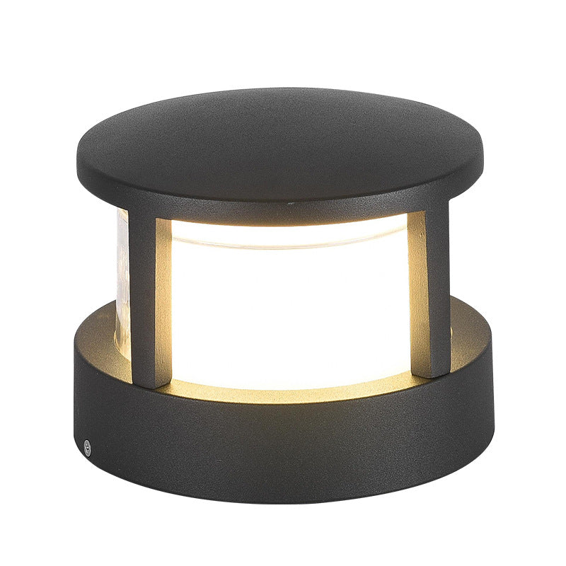 Close-up front view of the round black light with flat top, lit frosted diffuser and small screw detail on the base. 12