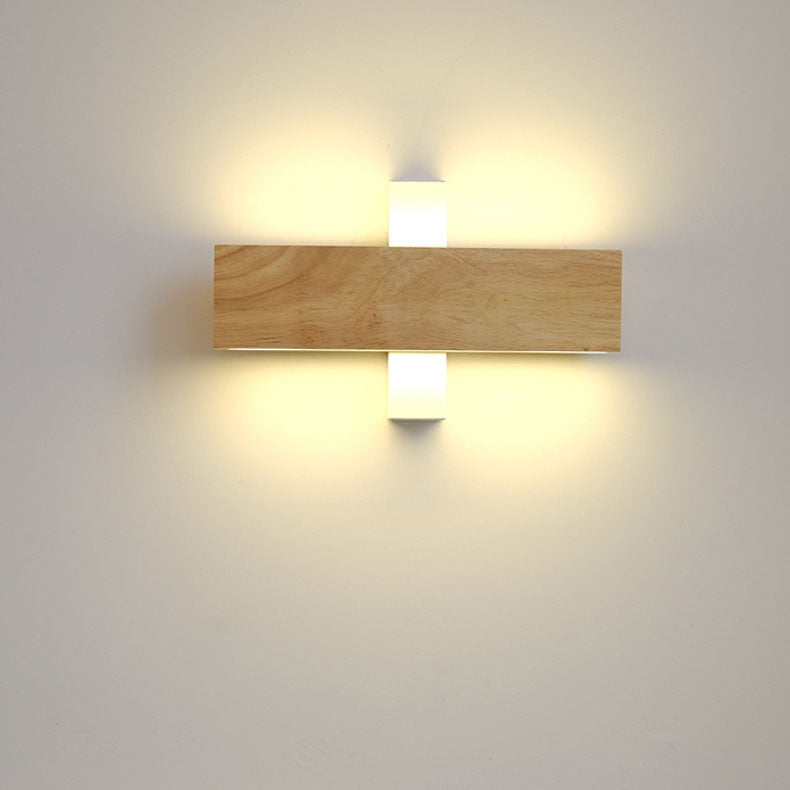 Wooden bar turned horizontally across its white bracket, with light glowing above and below it. 12