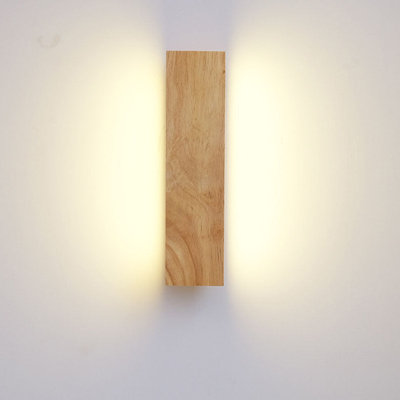 Front view of the wooden bar mounted vertically, with warm light spilling onto the wall on both sides. 3