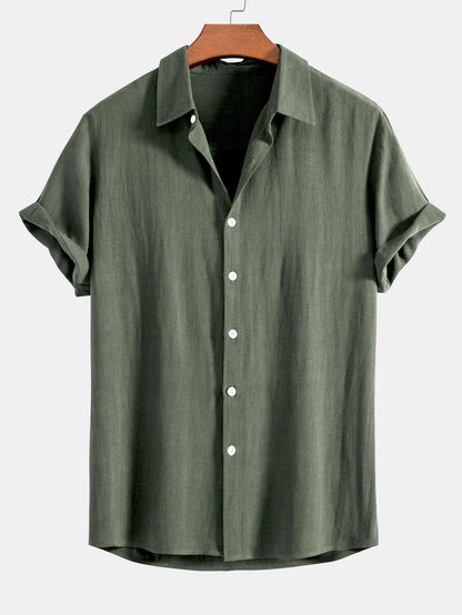 Short sleeve button-up shirt in olive green on a wooden hanger, with a soft collar and white buttons. 5
