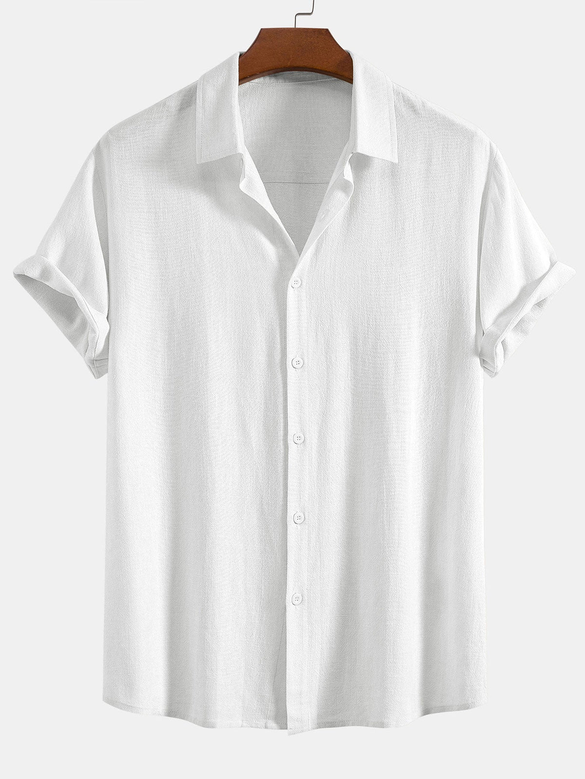 Short sleeve button-up shirt in white on a wooden hanger, showing the subtle woven texture and rolled sleeves. 6