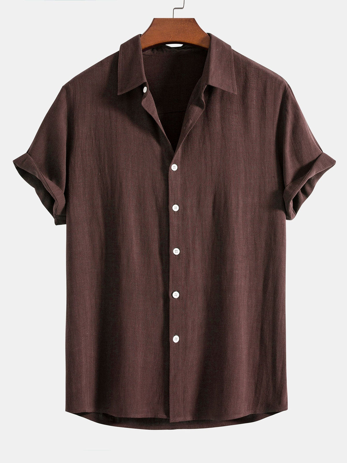 Short sleeve button-up shirt in dark chocolate brown on a wooden hanger, with cuffed sleeves and white buttons. 8