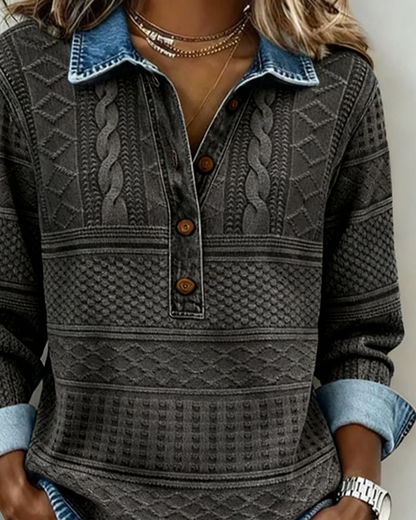 Close-up of the charcoal grey version's upper half, showing the blue collar, wooden buttons on the placket and braided cable panels. 6