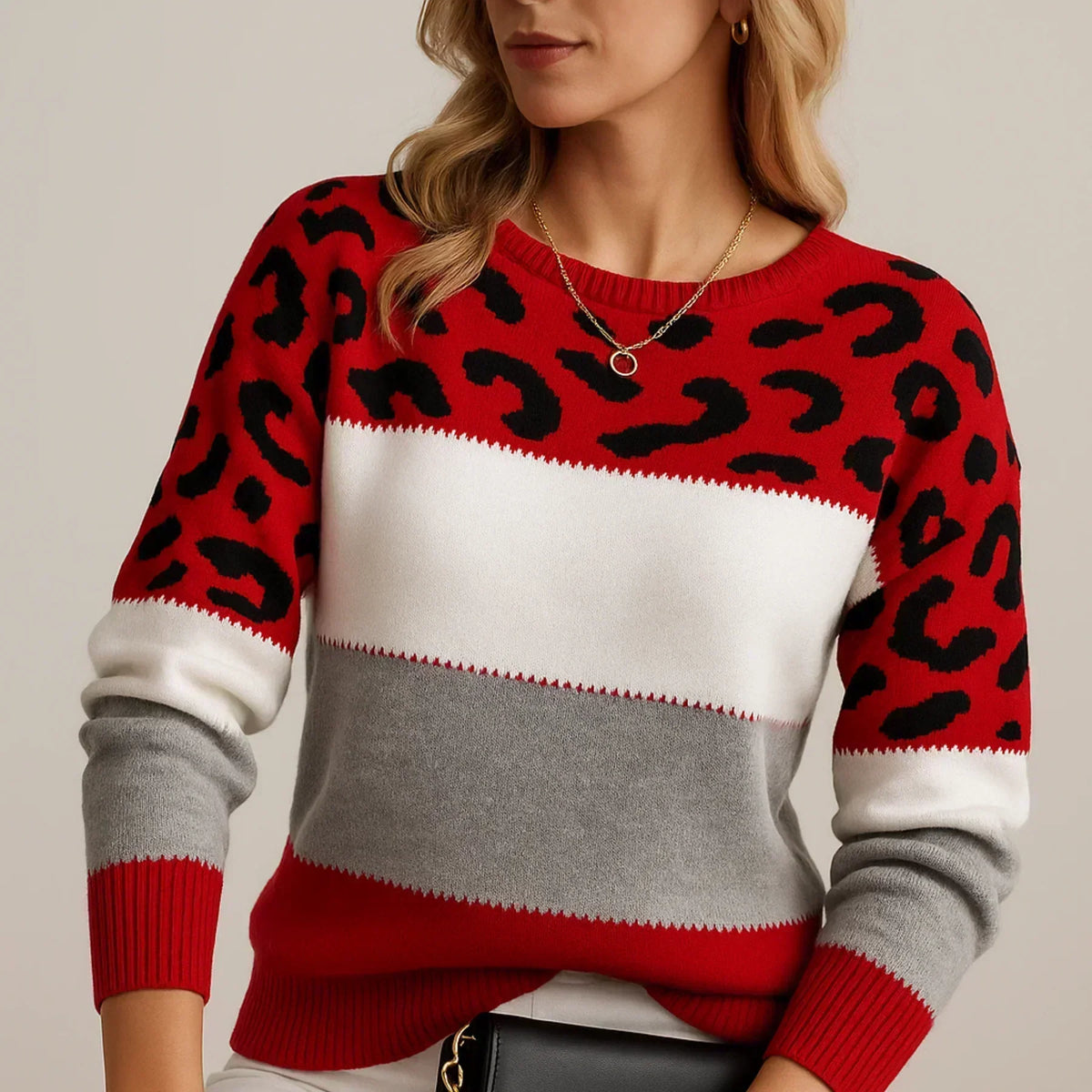 Model wearing the colour-block jumper in red, white and grey with black leopard print and red ribbed cuffs and hem. 4