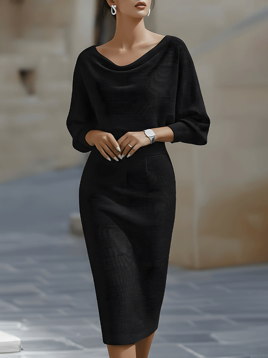 Model wearing the ribbed knit midi dress in black, front view, with draped neckline, batwing sleeves and fitted skirt. 1