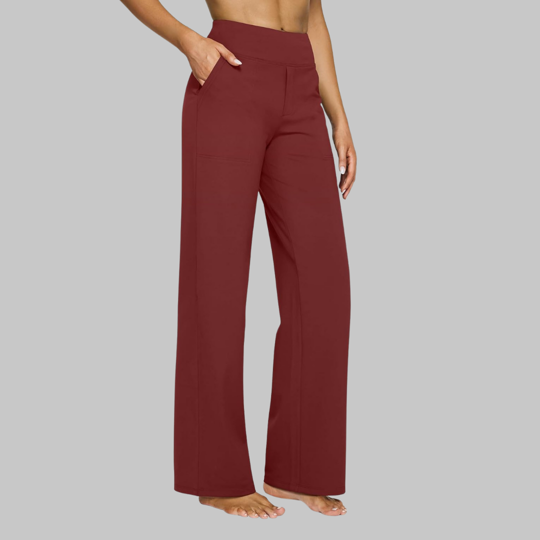 Deep red version of the high-waist straight-leg trousers, worn by a barefoot model with a hand in the pocket. 11