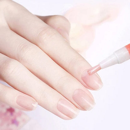 Close-up of hand with a pink pen brushing oil onto a nail 11