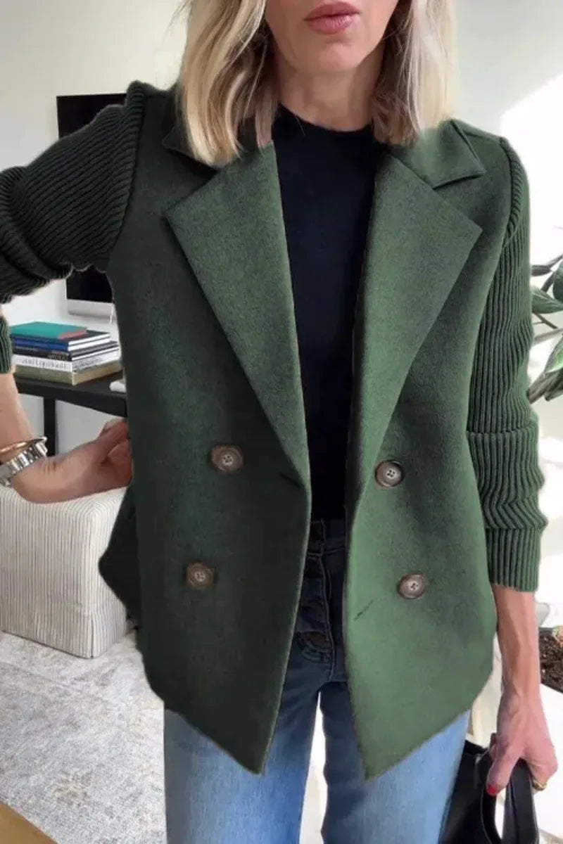 Close-up of green double-breasted jacket on model, showing collar, four buttons and ribbed sleeves 10