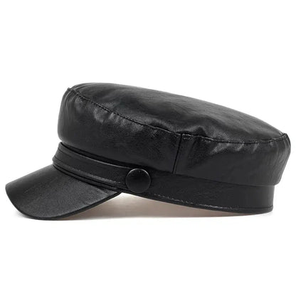 Black faux leather baker boy hat from the side, showing the covered button and rounded crown 10