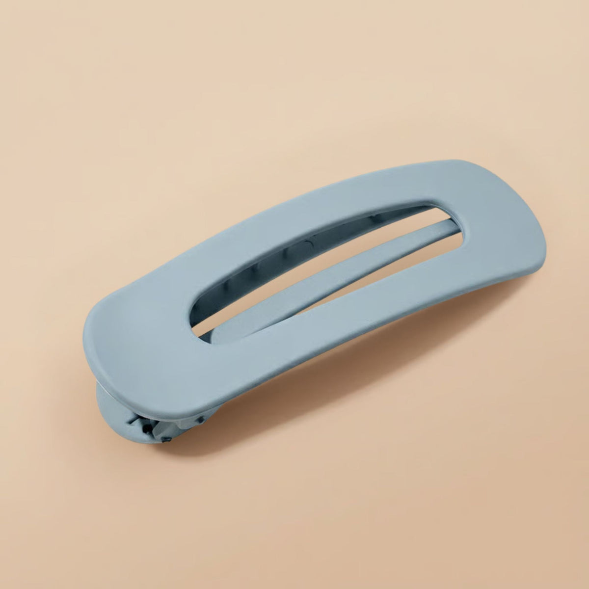 Matte dusty blue-grey slim flat clip at an angle, showing the hinge and inner teeth 10