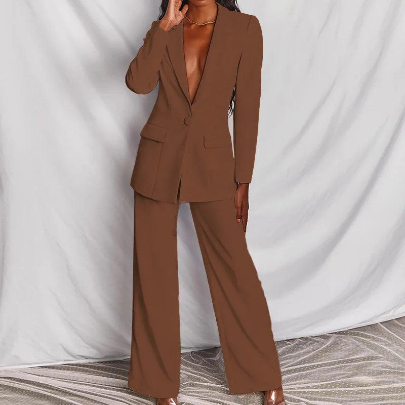 Chocolate brown blazer and wide-leg trousers, front view on a model with one hand raised near her collarbone 10