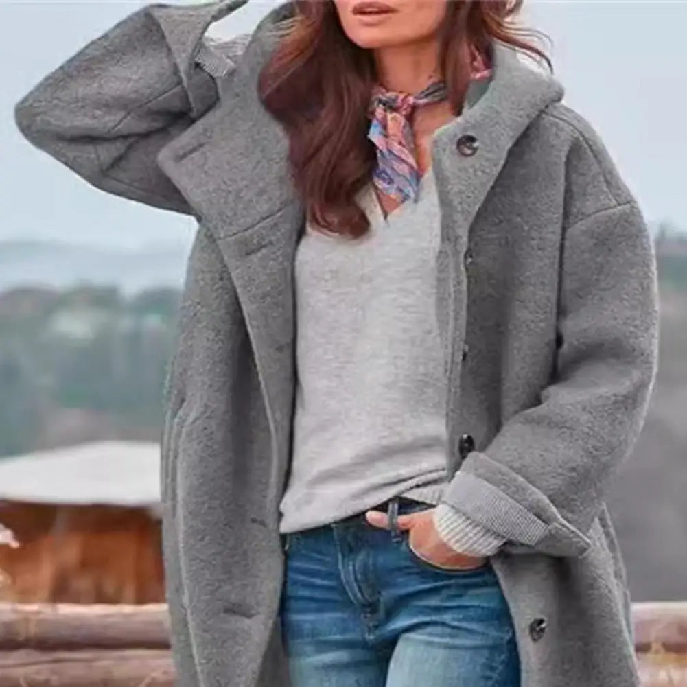 Close crop of the grey fleecy coat, showing the hood, buttons and rolled striped cuff 10