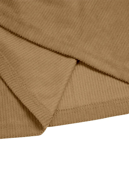 Close-up of the tan shirt's inner hem with visible overlocked stitching 10