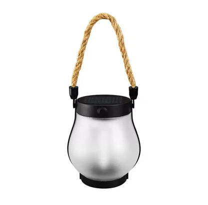 Unlit frosted glass lantern with a black top, solar panel and rope handle on white 11
